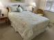 Cozy bedroom with a decorative floral comforter at 5320 Hyland Hills Ave # 2214, Sarasota, FL 34241