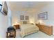 This bedroom has a ceiling fan and large window, creating a comfortable and well-lit living space at 5320 Hyland Hills Ave # 2214, Sarasota, FL 34241