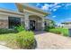 Inviting exterior entrance with stone accents, manicured greenery and brick walkway, creating curb appeal at 5320 Hyland Hills Ave # 2214, Sarasota, FL 34241