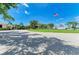 A grand entrance with lush landscaping, an American flag, and well-maintained grounds that creates a welcoming atmosphere at 5320 Hyland Hills Ave # 2214, Sarasota, FL 34241