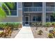 Charming condo with covered porch, lush landscaping, and well-maintained walkway at 5320 Hyland Hills Ave # 2214, Sarasota, FL 34241