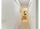 Hallway featuring closet doors and access to a bathroom with a spacious vanity and a toilet at 5320 Hyland Hills Ave # 2214, Sarasota, FL 34241