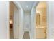 Hallway view showing access to the bathroom with a vanity and a view into a bedroom at 5320 Hyland Hills Ave # 2214, Sarasota, FL 34241