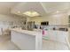 Bright kitchen features white cabinets, stainless steel appliances, and a breakfast bar for casual dining at 5320 Hyland Hills Ave # 2214, Sarasota, FL 34241