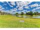 Tranquil lake surrounded by lush greenery and scenic walking paths, creating a serene residential oasis at 5320 Hyland Hills Ave # 2214, Sarasota, FL 34241
