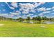 Breathtaking lake view with blue skies and lush greenery in a peaceful community setting at 5320 Hyland Hills Ave # 2214, Sarasota, FL 34241