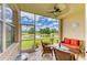 Relaxing screened lanai with comfortable seating and scenic views of the tranquil lake and lush landscaping at 5320 Hyland Hills Ave # 2214, Sarasota, FL 34241