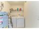 This laundry room features a washer and dryer and plenty of storage space at 5320 Hyland Hills Ave # 2214, Sarasota, FL 34241