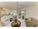 Open-concept living area with comfortable seating, a view of the patio, and integrated kitchen and dining space at 5320 Hyland Hills Ave # 2214, Sarasota, FL 34241