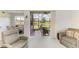 Cozy living room featuring plush seating and a view of the screened lanai overlooking the picturesque lake at 5320 Hyland Hills Ave # 2214, Sarasota, FL 34241