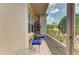 Screened porch view with an outdoor seating area and calming garden views at 5320 Hyland Hills Ave # 2214, Sarasota, FL 34241