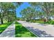 Picturesque street view with lush landscaping, mature trees, and a glimpse of an inviting home at 5320 Hyland Hills Ave # 2214, Sarasota, FL 34241