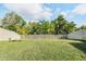 Large, well-maintained backyard with a pristine lawn and white privacy fence providing a serene outdoor space at 5426 Rainwood Meadows Dr, Apollo Beach, FL 33572