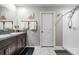 Bathroom featuring granite countertops, a double sink, and a walk-in shower at 5426 Rainwood Meadows Dr, Apollo Beach, FL 33572
