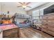 Well-lit bedroom featuring bunkbeds, hardwood floors, and a large window at 5426 Rainwood Meadows Dr, Apollo Beach, FL 33572