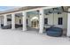 Relax on the patio with fans, lounge seating, and a ping pong table overlooking the community gate at 5426 Rainwood Meadows Dr, Apollo Beach, FL 33572
