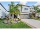Attractive two-story house with a well-kept lawn, a basketball hoop, and a two-car garage at 5426 Rainwood Meadows Dr, Apollo Beach, FL 33572