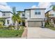 Charming two-story home with a well-manicured lawn, a basketball hoop, and a two-car garage at 5426 Rainwood Meadows Dr, Apollo Beach, FL 33572