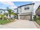 Lovely two-story house with a beautiful lawn, a basketball hoop, and a practical two-car garage at 5426 Rainwood Meadows Dr, Apollo Beach, FL 33572