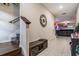 Inviting hallway featuring tile floors, a decorative clock, and a view into the living area at 5426 Rainwood Meadows Dr, Apollo Beach, FL 33572