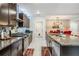 Beautiful kitchen featuring granite countertops, stainless steel appliances, and dark wood cabinets at 5426 Rainwood Meadows Dr, Apollo Beach, FL 33572