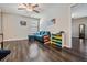 Cozy living room with dark hardwood floors, a ceiling fan, and a blue couch at 5426 Rainwood Meadows Dr, Apollo Beach, FL 33572