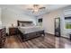 Spacious main bedroom with a ceiling fan, two windows, and an ensuite bathroom at 5426 Rainwood Meadows Dr, Apollo Beach, FL 33572