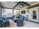 Relaxing enclosed patio with comfortable wicker furniture, mounted TV, and stylish decor for outdoor enjoyment at 5426 Rainwood Meadows Dr, Apollo Beach, FL 33572