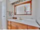 Bright bathroom featuring a wooden vanity with ample storage and a large mirror at 5619 Bayshore Rd # 211, Palmetto, FL 34221