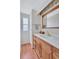 Bright bathroom featuring a wooden vanity with ample storage and a window at 5619 Bayshore Rd # 211, Palmetto, FL 34221