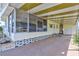 Spacious screened-in porch with ample seating area, offering a relaxed outdoor living space with sunny decor at 5619 Bayshore Rd # 211, Palmetto, FL 34221