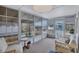 Enclosed sunroom with wall-to-wall windows offering plenty of natural light and comfortable seating at 5619 Bayshore Rd # 211, Palmetto, FL 34221
