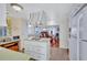 Cozy kitchen with a central island cooktop, white cabinets, and adjoining dining and living areas at 5619 Bayshore Rd # 211, Palmetto, FL 34221
