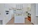 Bright kitchen boasts a central cooktop island, all-white cabinetry, and a convenient door to the outside at 5619 Bayshore Rd # 211, Palmetto, FL 34221