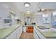 Well-lit kitchen featuring a sink with a window, ample countertop space, and a functional cooktop island at 5619 Bayshore Rd # 211, Palmetto, FL 34221