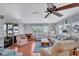 Bright living room boasts wood floors, ceiling fan, comfortable seating, and large windows for natural light at 5619 Bayshore Rd # 211, Palmetto, FL 34221