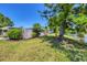Picturesque backyard featuring a calm water feature, mature trees, and grassy lawn for outdoor enjoyment at 5675 Saint Louis Ave, Sarasota, FL 34233