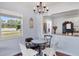 Cozy dining area adjacent to the kitchen with a modern chandelier at 5675 Saint Louis Ave, Sarasota, FL 34233