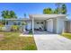 Charming home featuring a covered carport and well-kept front yard at 5675 Saint Louis Ave, Sarasota, FL 34233