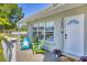 Inviting front porch with colorful Adirondack chairs and a welcome mat at 5675 Saint Louis Ave, Sarasota, FL 34233