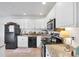 The kitchen features white cabinets and modern appliances at 5675 Saint Louis Ave, Sarasota, FL 34233