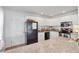 Bright kitchen features white cabinets, stainless steel appliances, and a granite countertop at 5675 Saint Louis Ave, Sarasota, FL 34233