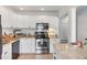 This bright kitchen features white cabinets and a granite countertop at 5675 Saint Louis Ave, Sarasota, FL 34233