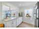 Kitchen view with white cabinets, granite countertops, and stainless steel appliances at 5675 Saint Louis Ave, Sarasota, FL 34233