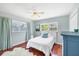 Cozy bedroom with hardwood floors, ceiling fan and natural light at 5675 Saint Louis Ave, Sarasota, FL 34233
