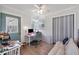 Bright office space featuring a ceiling fan, hardwood floors, desk and chair near a window at 5675 Saint Louis Ave, Sarasota, FL 34233