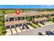 Aerial view of condos featuring tile roofs, garages, and a golf course in the background at 5694 Palmer Cir # 202, Bradenton, FL 34211