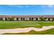 Aerial view of condos with tile roofs backing onto a green golf course at 5694 Palmer Cir # 202, Bradenton, FL 34211