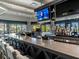 Relaxing bar featuring a long counter, TV, and tropical views through expansive windows at 5694 Palmer Cir # 202, Bradenton, FL 34211