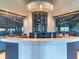 Stunning wine bar features a curved counter, sleek monitors, and a glass-enclosed wine display at 5694 Palmer Cir # 202, Bradenton, FL 34211